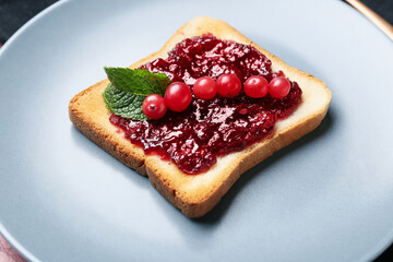 Plate with toast and cranberry jam, closeup