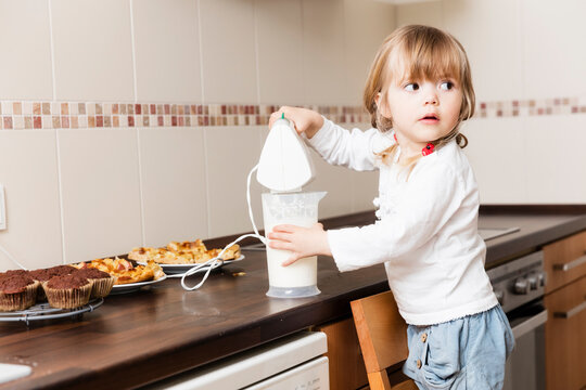 Girl whipping cream in kitchen