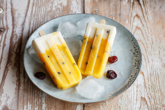 Homemade popsicles with mango and passion fruit