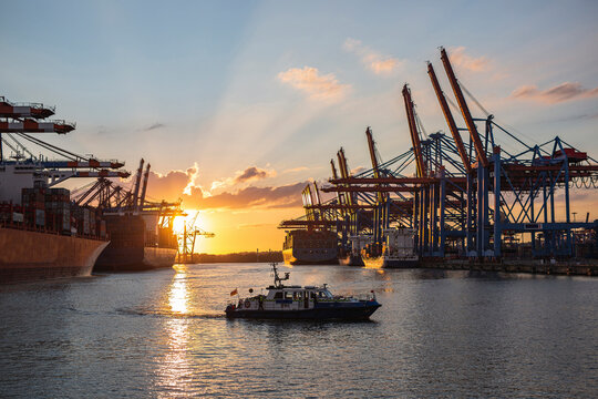 Germany,&Ocirc;&oslash;&Omega;Hamburg, Motorboat sailing in Port of Hamburg&Ocirc;&oslash;&Omega;at sunset