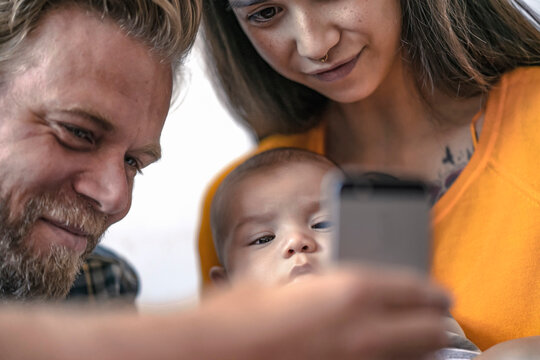 Family with baby using cell phone