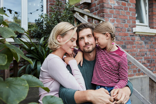 Family sitting on stairs cuddling