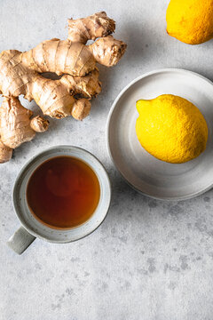 Studio shot of cup of tea, lemons and ginger root