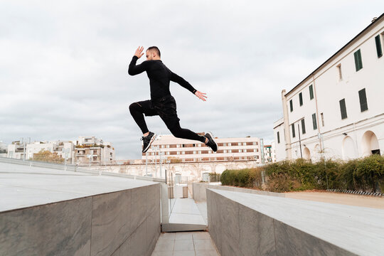 Man jumping on wall against clear sky