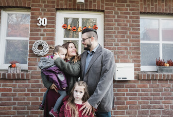 Portrait of family in front of their house