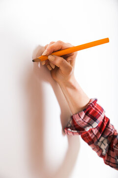Woman marking with pencil on a wall