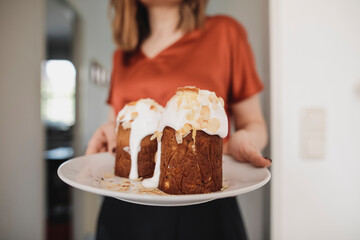Woman serving garnished cake on plate