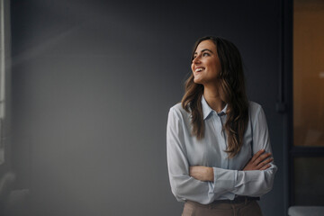 Portrait of happy young businesswoman looking sideways