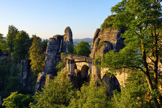 Germany, Saxony, Elbe Sandstone Mountains, view to the Bastei rock formation at sunrise with Bastei Bridge