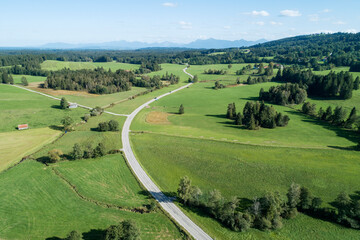 Germany, Bavaria, Drone view of rural road and green countryside in summer
