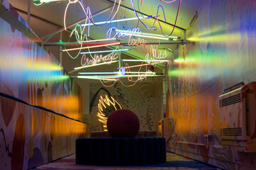 Room illuminated by colorful neon signs