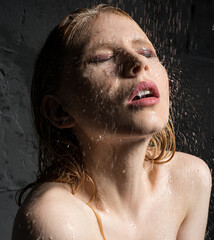 Girl's face on which drops of water fall portrat