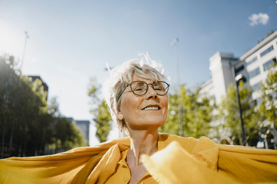 Portrait of smiling mature woman enjoying sunlight