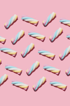 Pattern of marshmallows against pink background