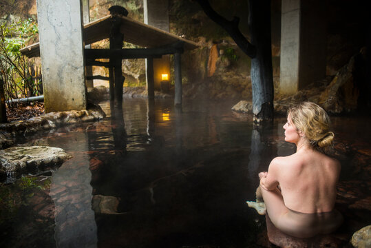 Japan, Kyushu, woman enjoying hot springs
