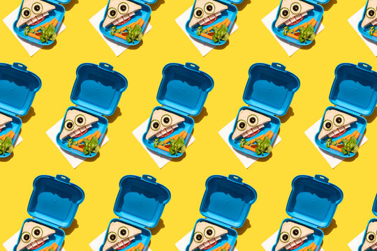 Pattern of lunch boxes with baby carrots and funny looking sandwiches with anthropomorphic faces