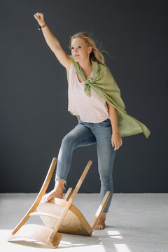 Portrait of blond young womanposing as a superheroine