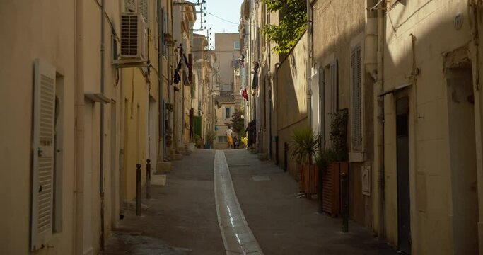unrecognizable people playing soccer in picturesque alleyway, Ciotat