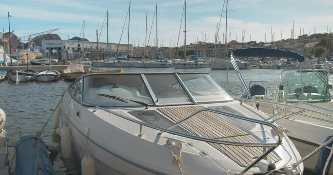 Luxurious white speedboat docked by pier in small town provence in Cassis France