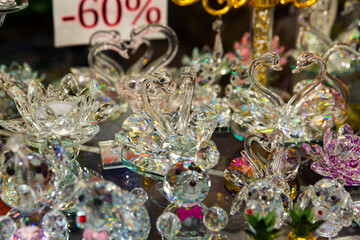 Colorful souvenirs from famous Bohemian crystal on showcase of specialty shop..