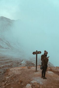 Woman with cell phone at Ijen volcano, Java, Indonesia
