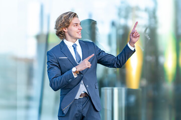 Cheerful young businessman gesturing against glass office building