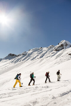 Group of friends ski touring up to a mountain peak, Achenkirch, Austria