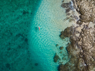 Aerial view of female surfer, Sumbawa, Indonesia