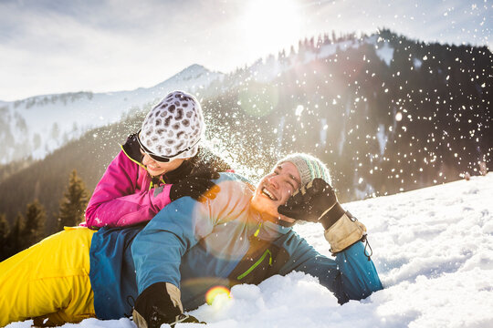 Carefree couple lying in snow