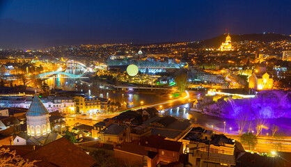 Picturesque night view of Tbilisi with bridges over Kura river, capital of Georgia © JackF