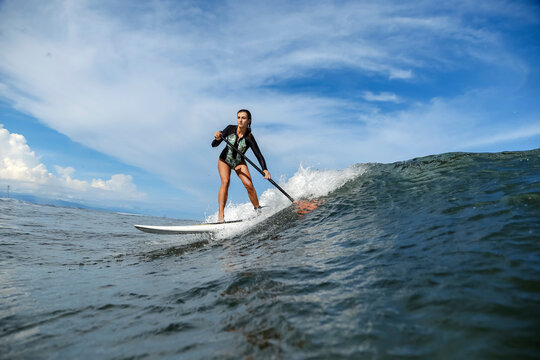 Female SUP surfer, Bali, Indonesia