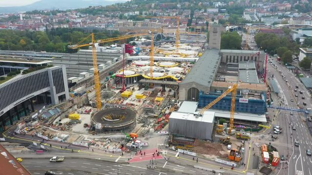 Aerial helix of huge railroads and construction site of main train station Stuttgart S21 with cranes and construction workers in Stuttgart, Germany.