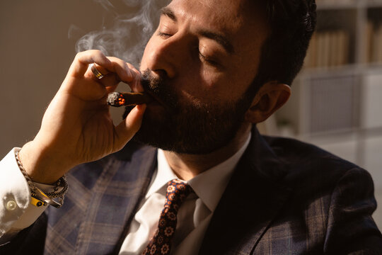 Portrait of bearded man smoking cigar