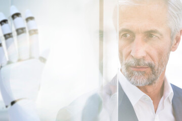 Businessman watching robot hand, close up