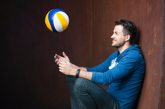 Smiling man throwing ball