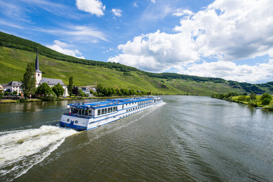 Cruise ship on Mosel River against cloudy sky, Bernkastel-kues, Germany