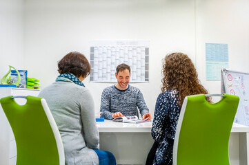 Two women with instructor in driving school