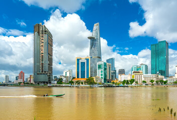 Obraz premium Skyscrapers along river with architecture office towers, hotels, center cultural and commercial development country most in Ho Chi Minh city, Vietnam