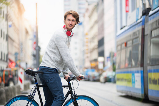 Portrait Of Young Man With Bicycle In The City