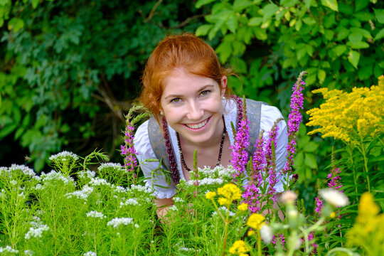 Portrait of redheaded teenage girl in garden
