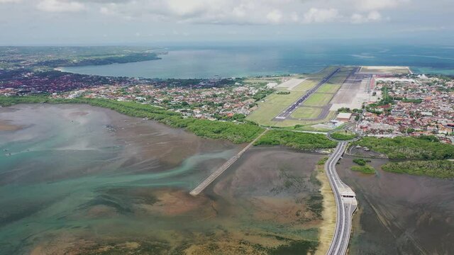 Aerial Drone Footage Commercial Airplane Taking Off From International Airport In Bali. Airliner Jet Speeding Up And Rising Into The Sky At Local Airport