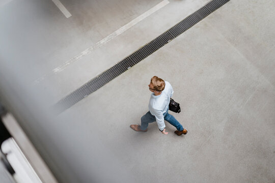 High angle view of businessman walking in city