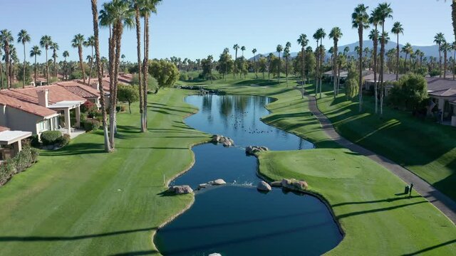 Flying over a par 3 with a lake on a golf course in Palm Desert, CA.