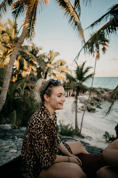 Mexico, Quintana Roo, Tulum, portrait of smiling young woman relaxing on the beach