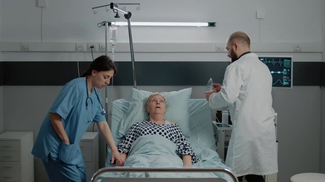 Medical team rushing to help patient with respiratory problem in hospital ward bed. Doctor using oxygen tube mask to cure hyperventilating and disease of retired patient with sickness.