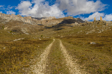 Mountain landscape and a road leading up to two old dilapidated watchtowers