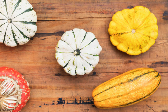 Various homegrown squashes on wooden surface