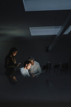 Team of business people working late in office, disussing solutions