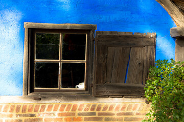 Traditional Dutch farmhouse window with old shabby shutters Arnhem, Netherlands