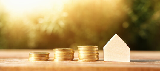 Wooden house model outdoors. Investment or real estate concept